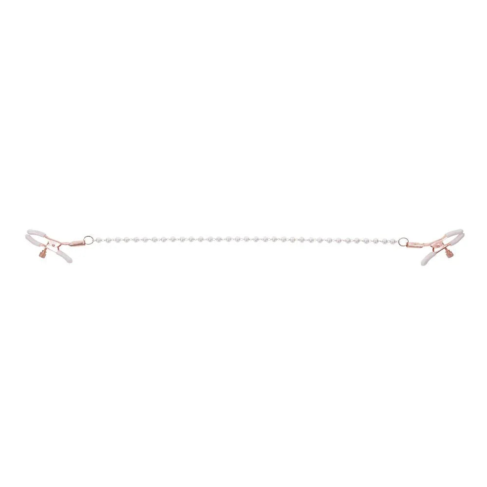 Pearl nipple clamps pulled apart with the pearl chain stretched straight