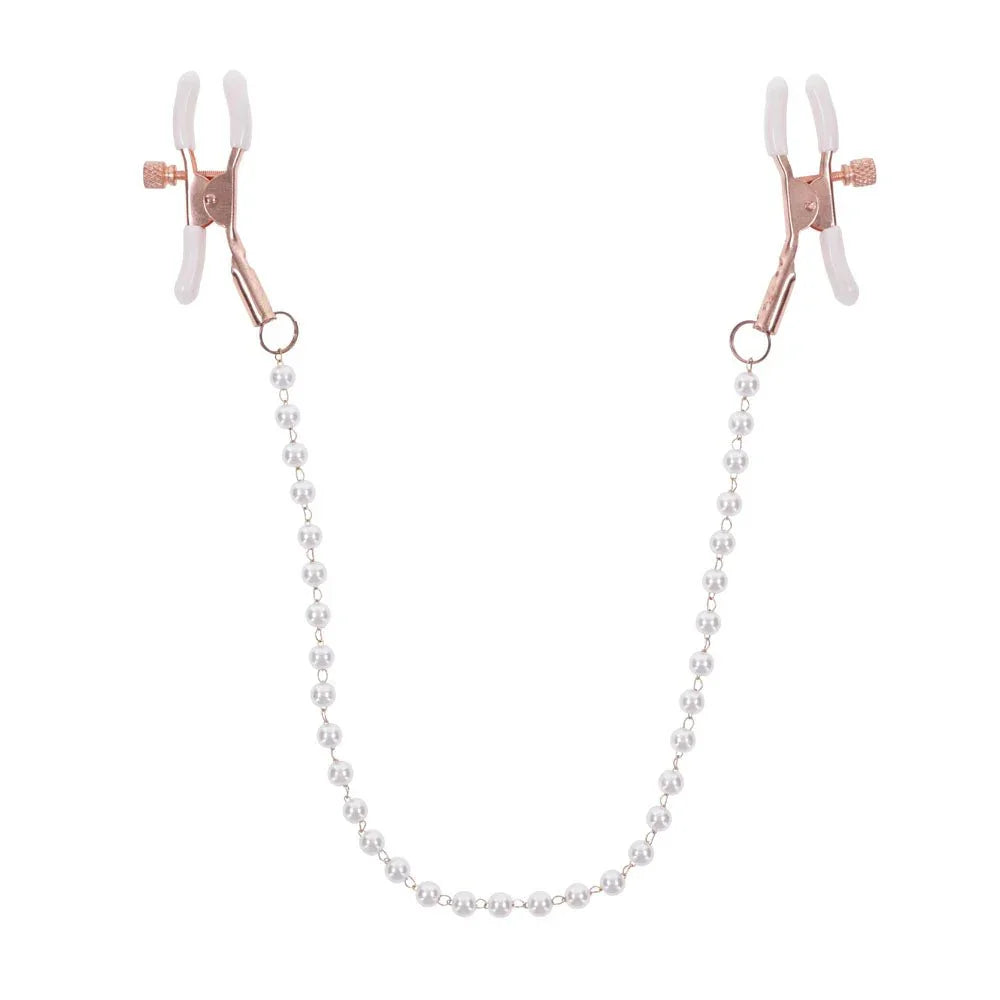 Rose gold nipple clamps with white tips joined by a faux pearl chain, hanging in a U