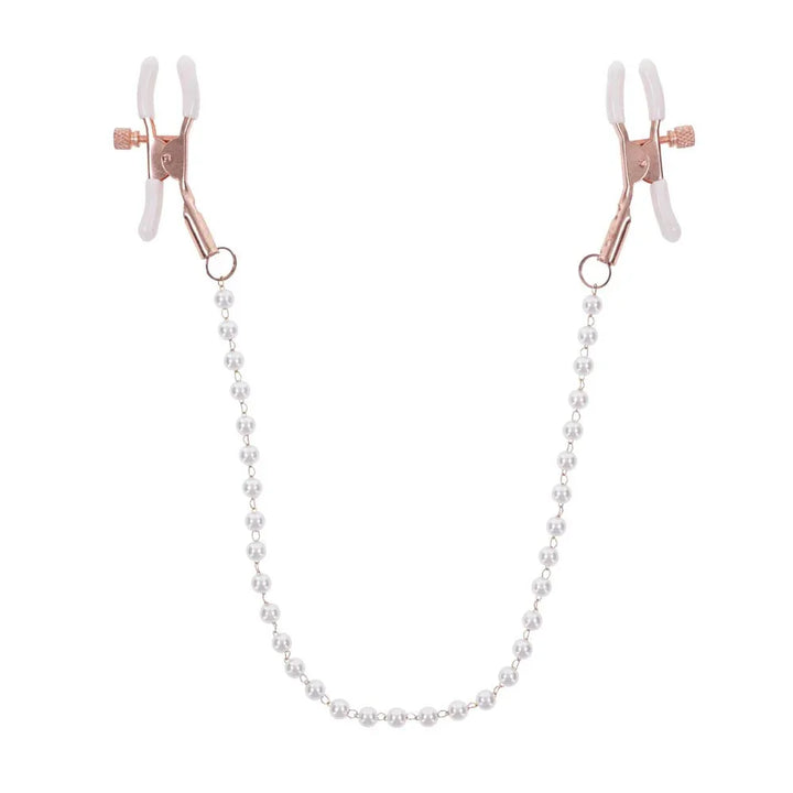 Rose gold nipple clamps with white tips joined by a faux pearl chain, hanging in a U