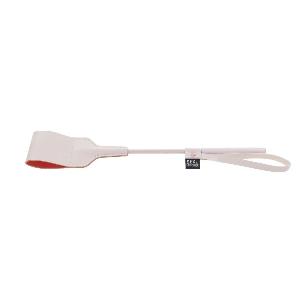 Peach riding crop angled, coral lining visible on the folded tip