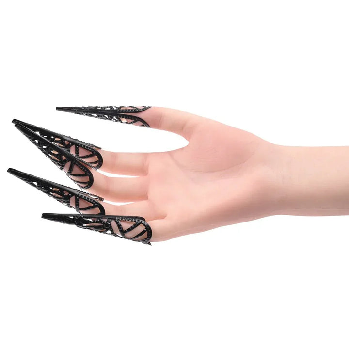 Hand wearing the metal claw fingertips, fingers curled toward the camera