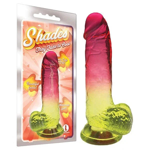 Shades jelly dong fading pink to yellow on a suction base, beside its blister pack