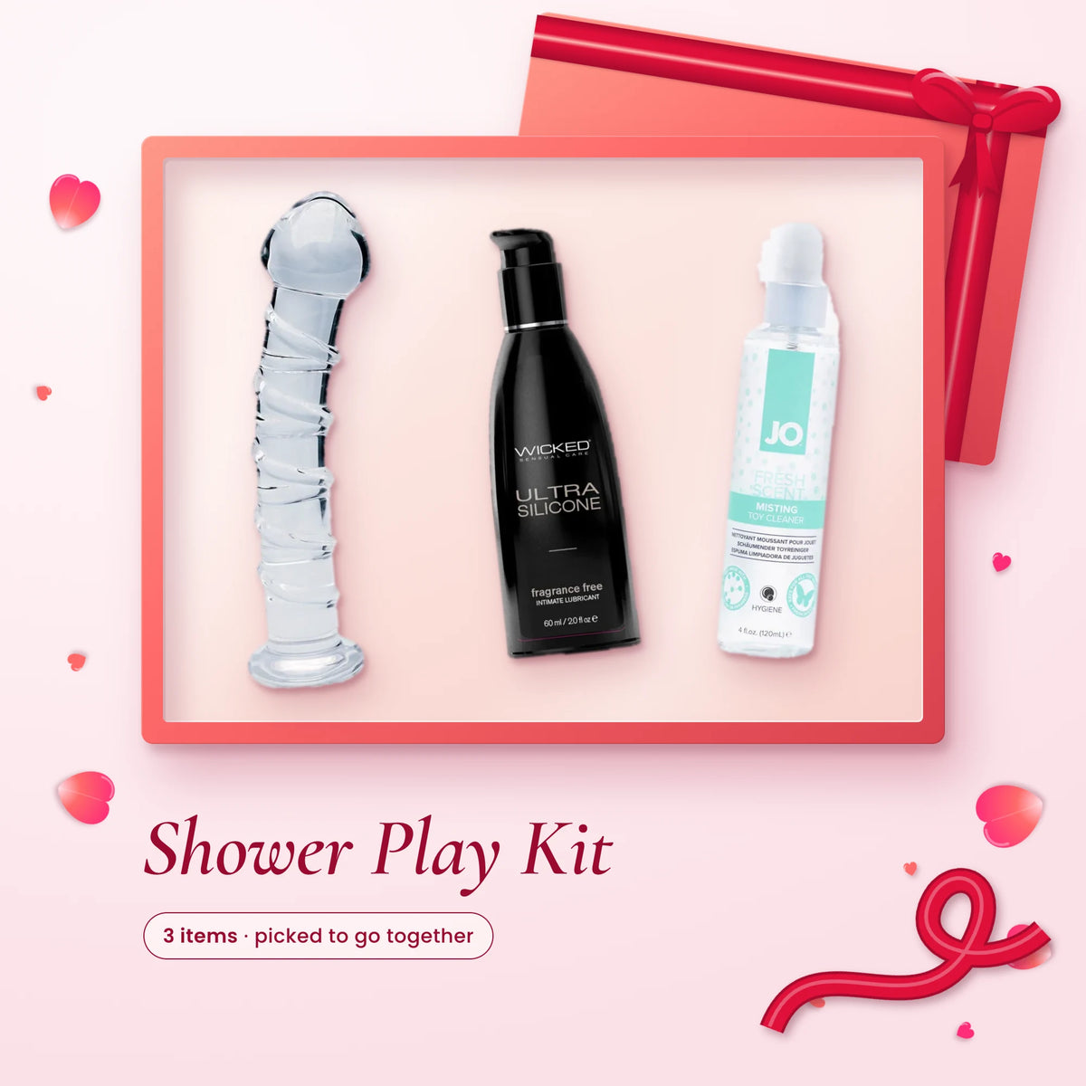 Shower Play Kit: a clear spiral glass dildo, Wicked Ultra silicone lube and JO misting toy cleaner on a pink backdrop