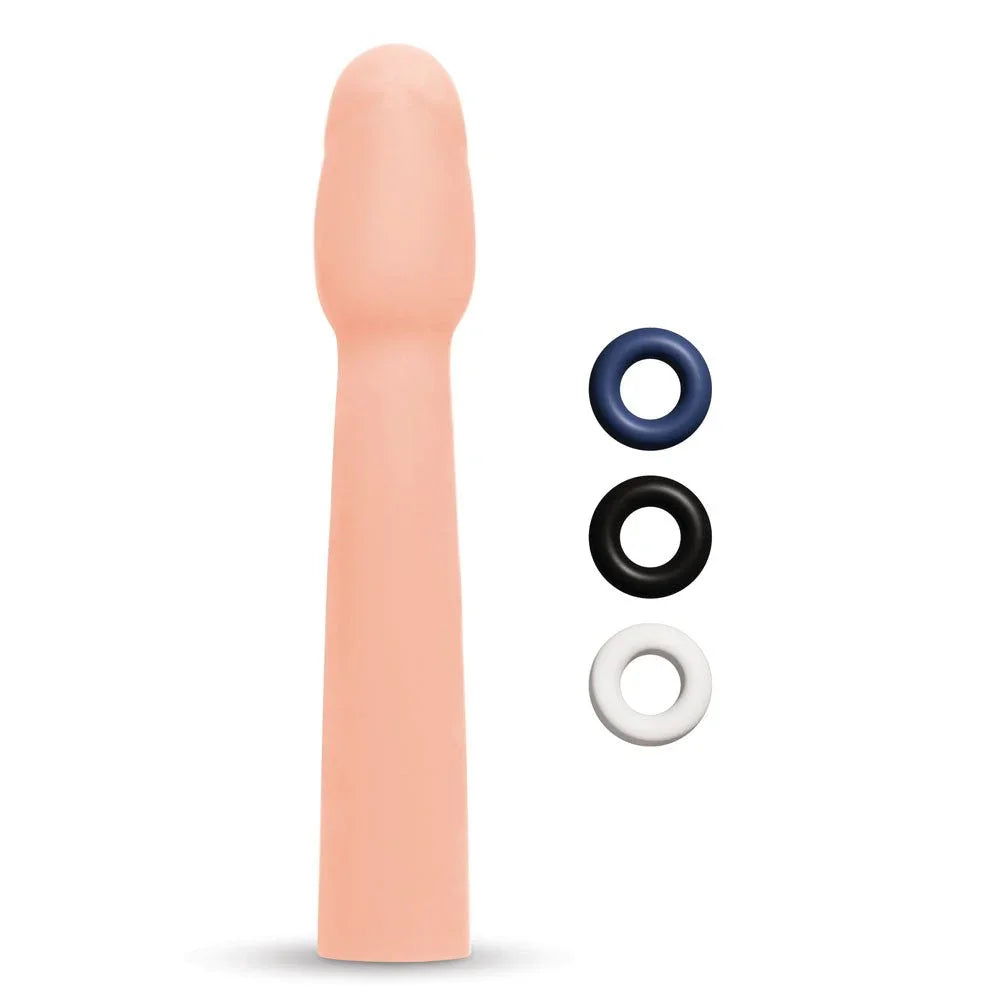 Size Up 2 inch realistic extender in Flesh upright beside blue, black and white rings