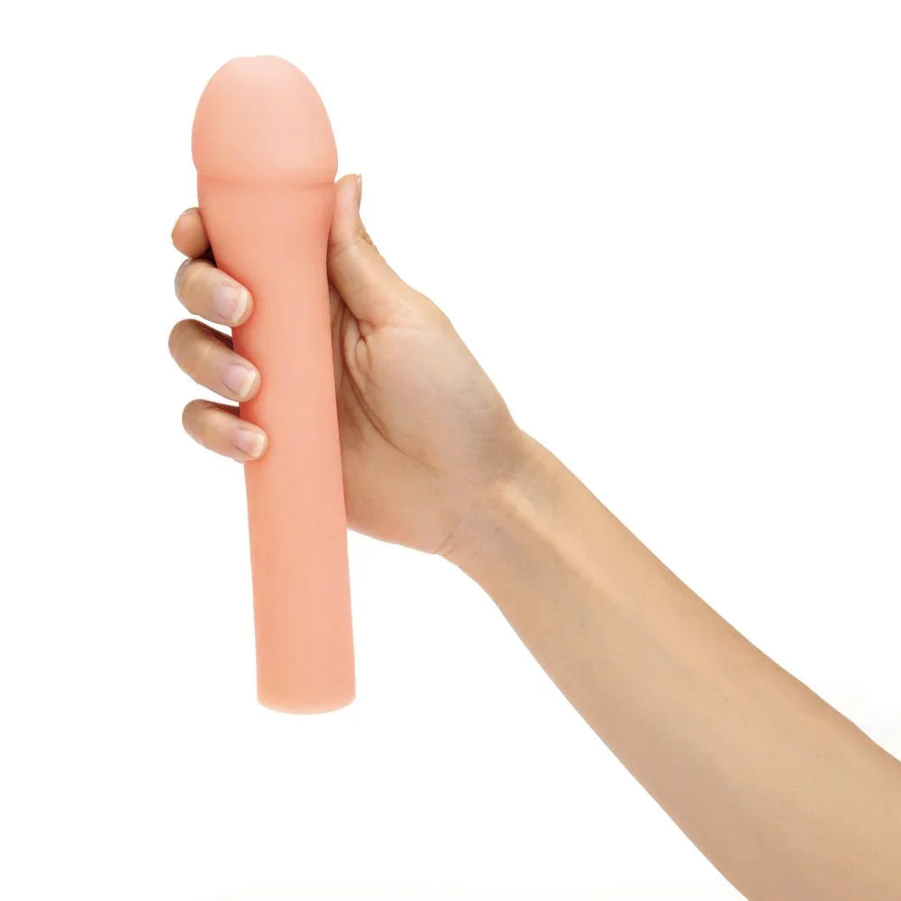 A hand gripping the flesh Size Up 3 inch realistic extender upright