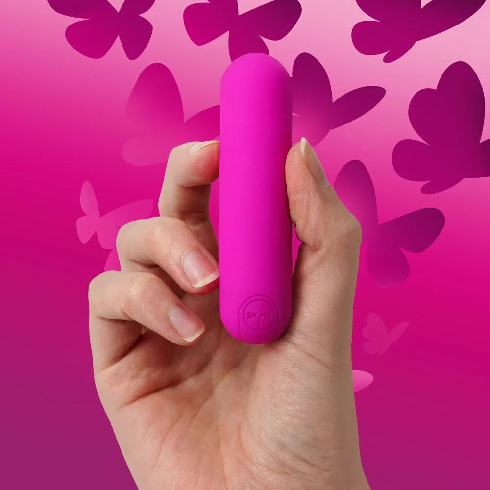 Super Excite bullet gripped in a hand, butterfly art background