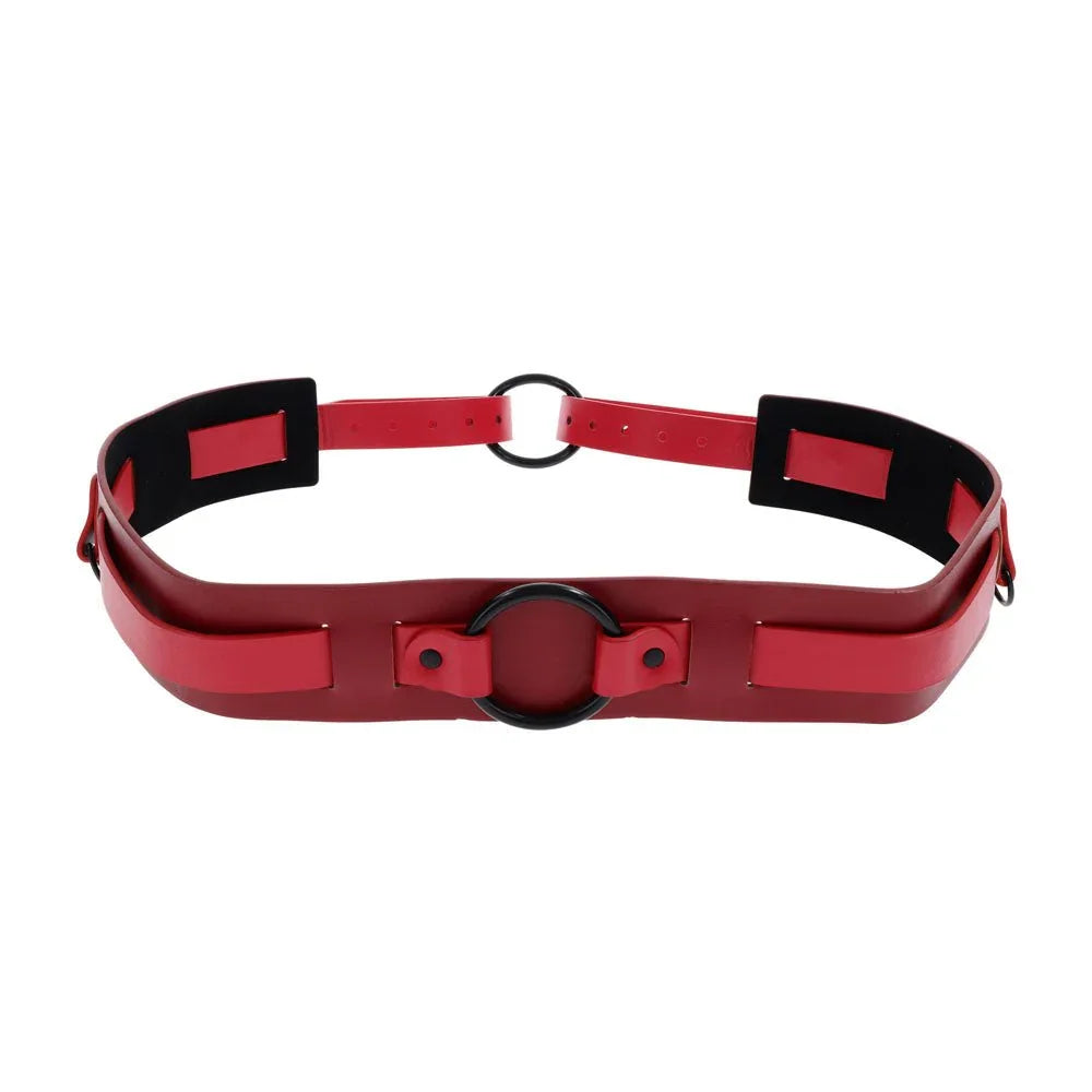 Red faux-leather belt harness with a black O-ring at the centre front, angled