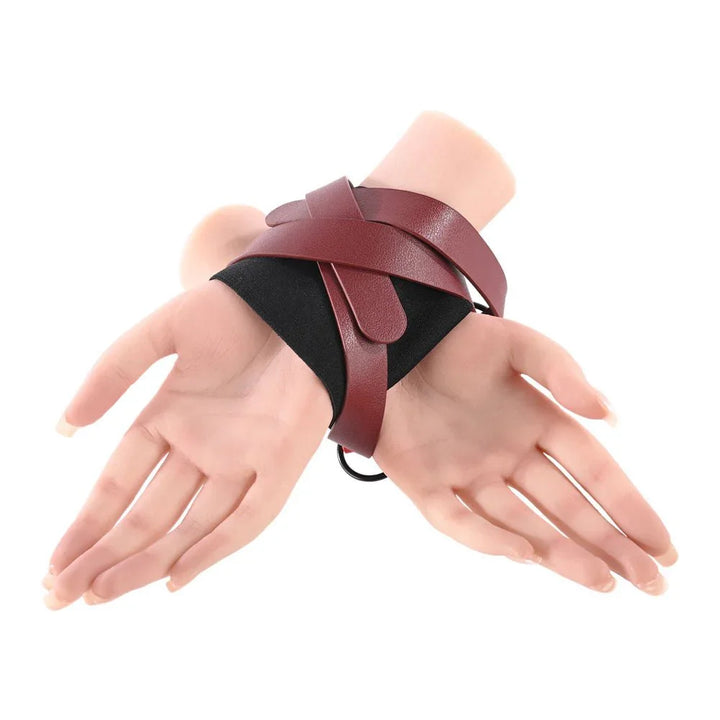 Mannequin hands with the burgundy straps wrapped over the black cuff