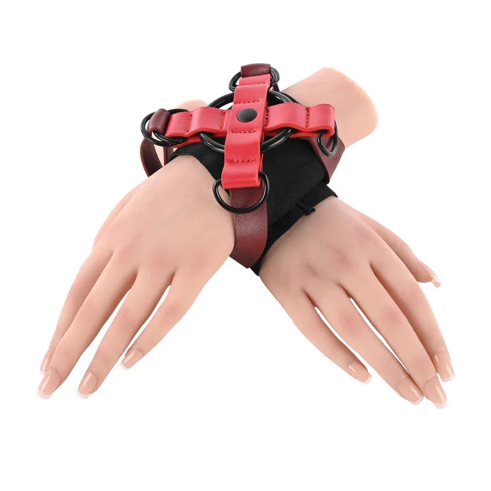 Mannequin wrists crossed and bound in the red and black X-shaped cuff