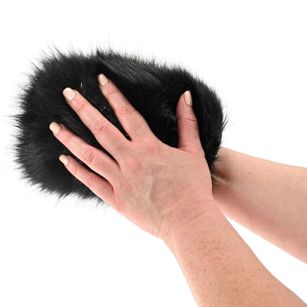 Hand wearing the Spiked Sensory Mitt with the black fur facing up