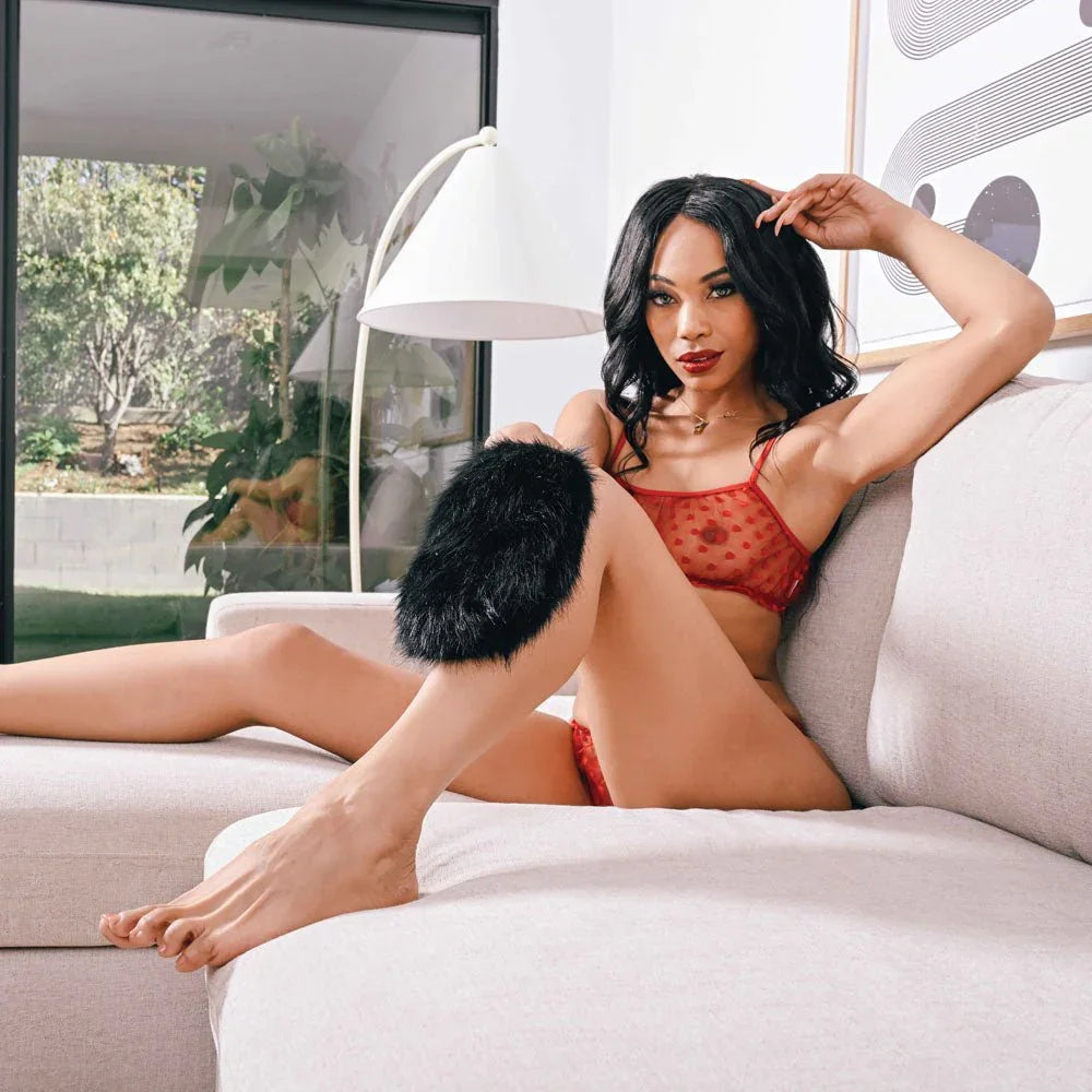 Model reclining on a sofa with the fur sensory mitt on her forearm