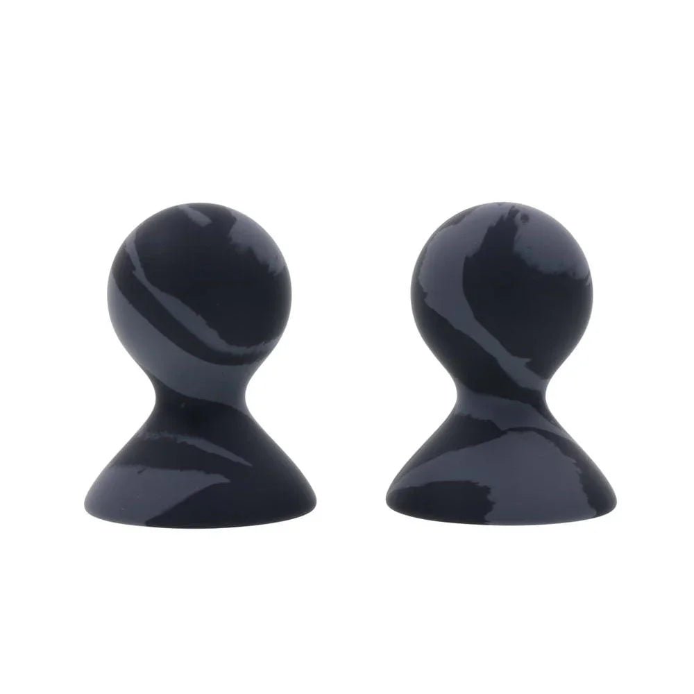 Pair of marbled black silicone nipple suckers standing upright, bulbs uppermost