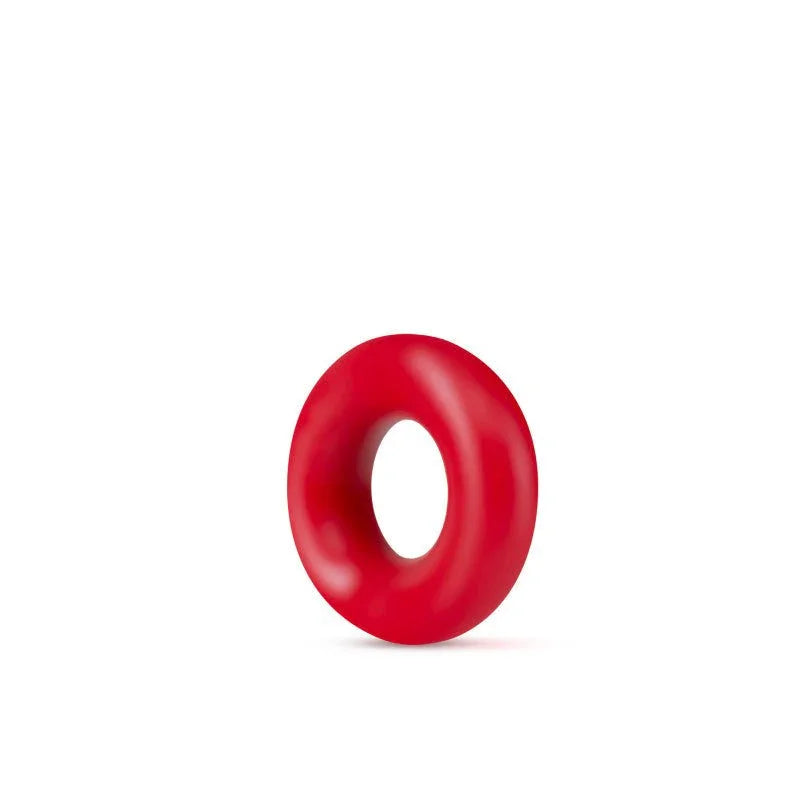 A single red Stay Hard Donut Ring on white, thick rounded silicone profile