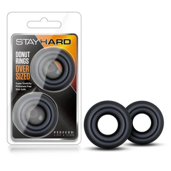 Stay Hard Donut Rings Oversized in black, two large rings beside the blister pack