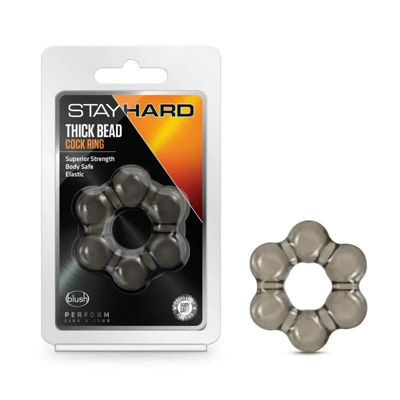 Stay Hard Thick Bead cock ring in smoke black beside its blister pack