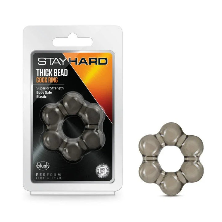 Stay Hard Thick Bead cock ring in smoke black beside its blister pack