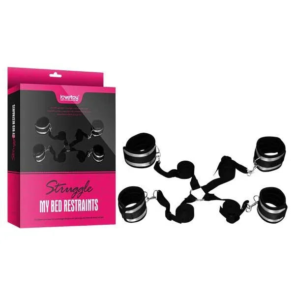 Lovetoy Struggle My Bed Restraints kit, four black cuffs on a strap web beside its pink box