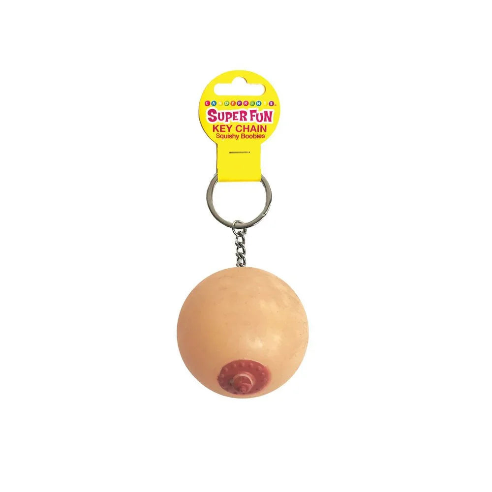 Super Fun squishy boob keychain in flesh tone, on its yellow Super Fun card