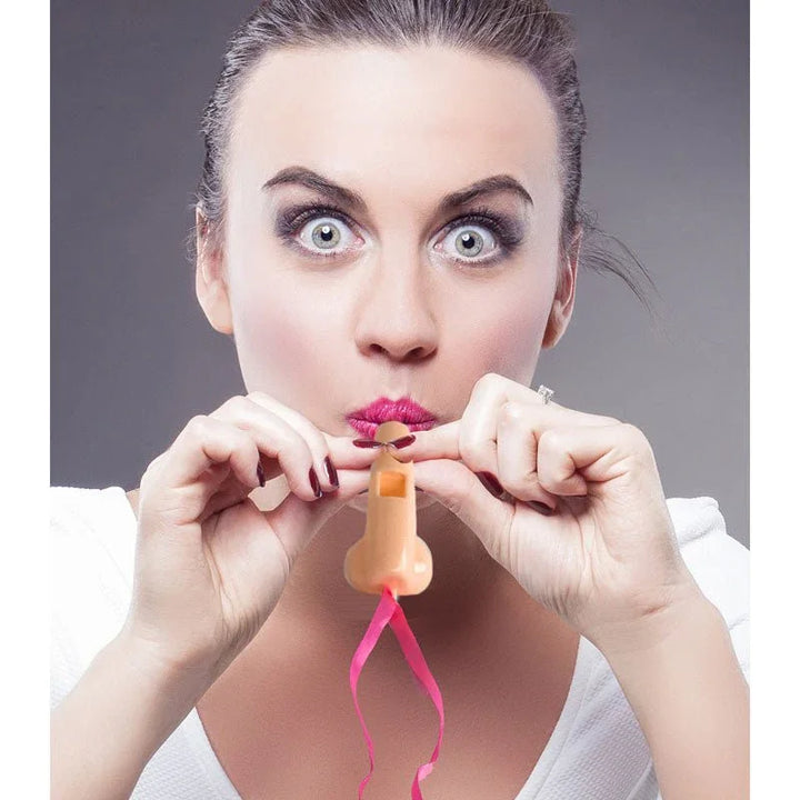 A woman blowing a Super Fun Penis party whistle on its pink ribbon
