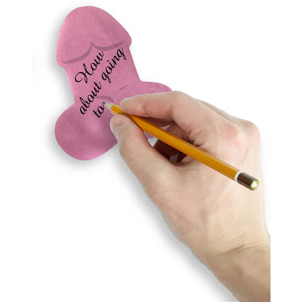 A hand writing a message on a pink Super Fun Penis sticky note