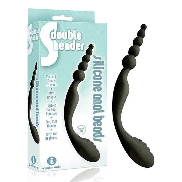 The 9's S-Double Header double ended anal beads in Black beside its retail box