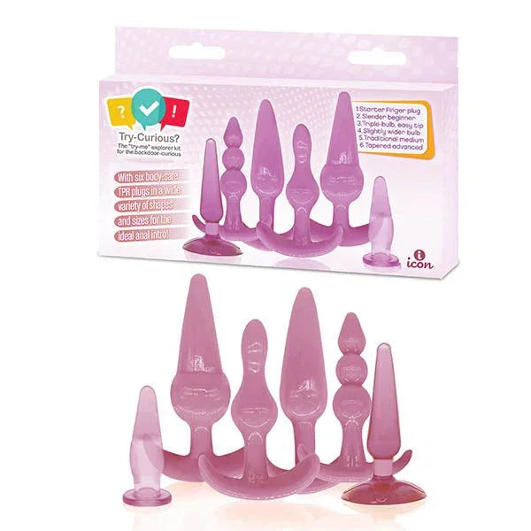 Try-Curious anal kit retail box above the six graduated pink TPR plugs laid out in a row