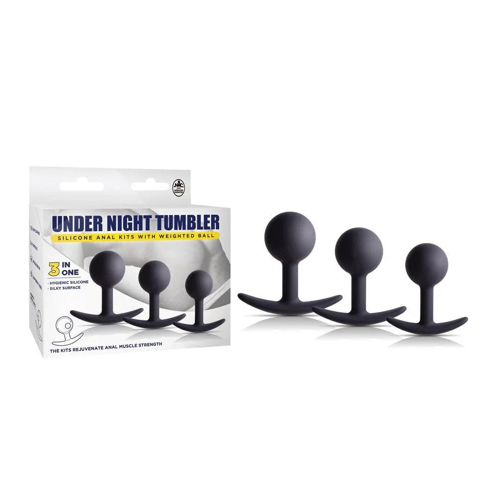 Under Night Tumbler weighted butt plug set in Black, three ball plugs beside the box