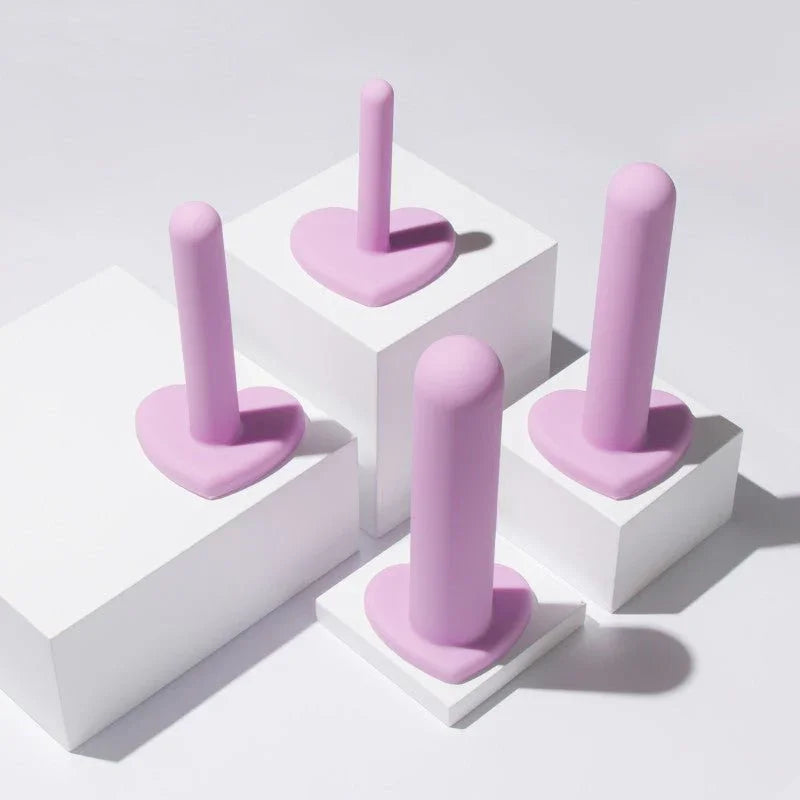 Four lilac Wellness dilators standing on white display blocks at different heights
