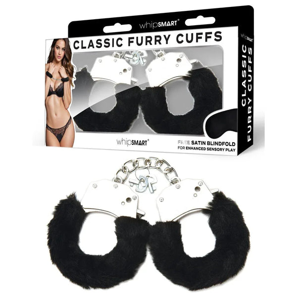 WhipSmart Classic Furry Cuffs in Black laid in front of their retail box