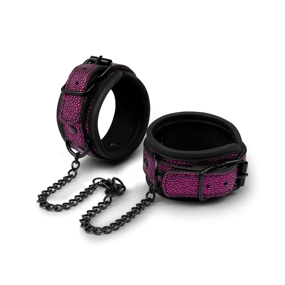 Dragon's Lair cuffs alone on white, purple dragon-skin texture with black chain clips