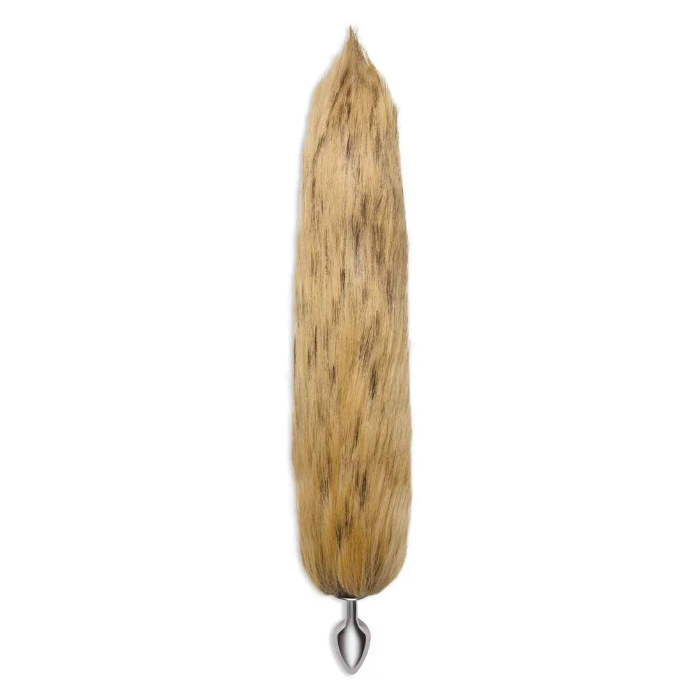Brown fox tail hanging straight down on white with the metal plug at the bottom