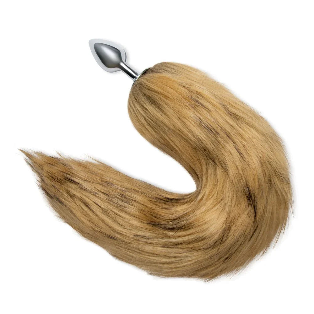 Brown fox tail curled into a hook on white, the metal plug pointing upward