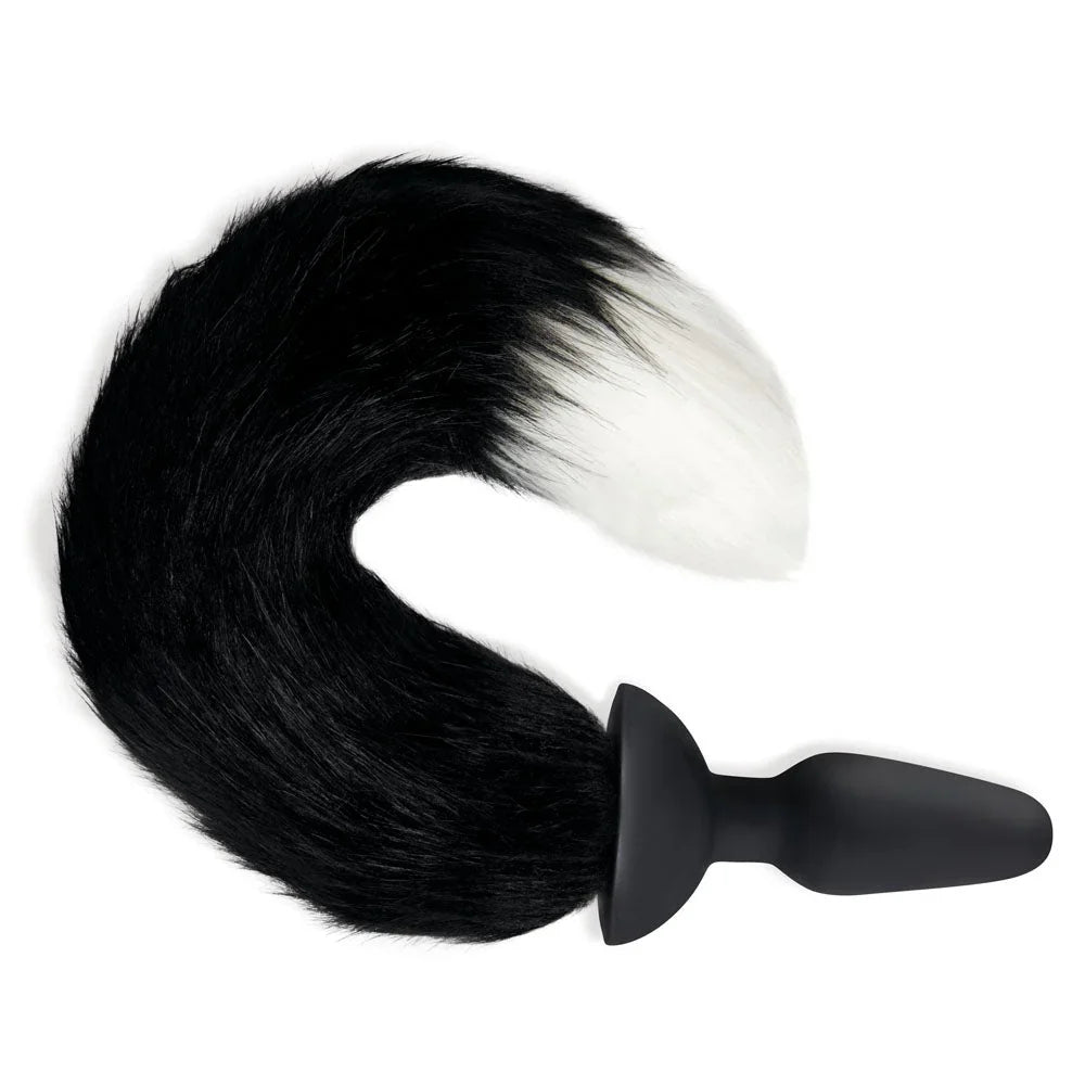 Black and white foxtail curled to the left on white, showing the ridged silicone plug