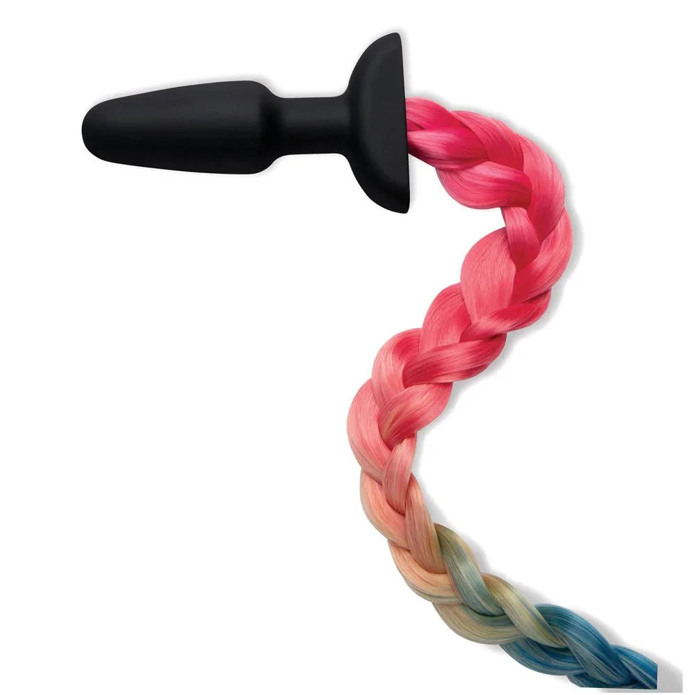 Rainbow braided tail coiled on white with the black silicone plug at the top