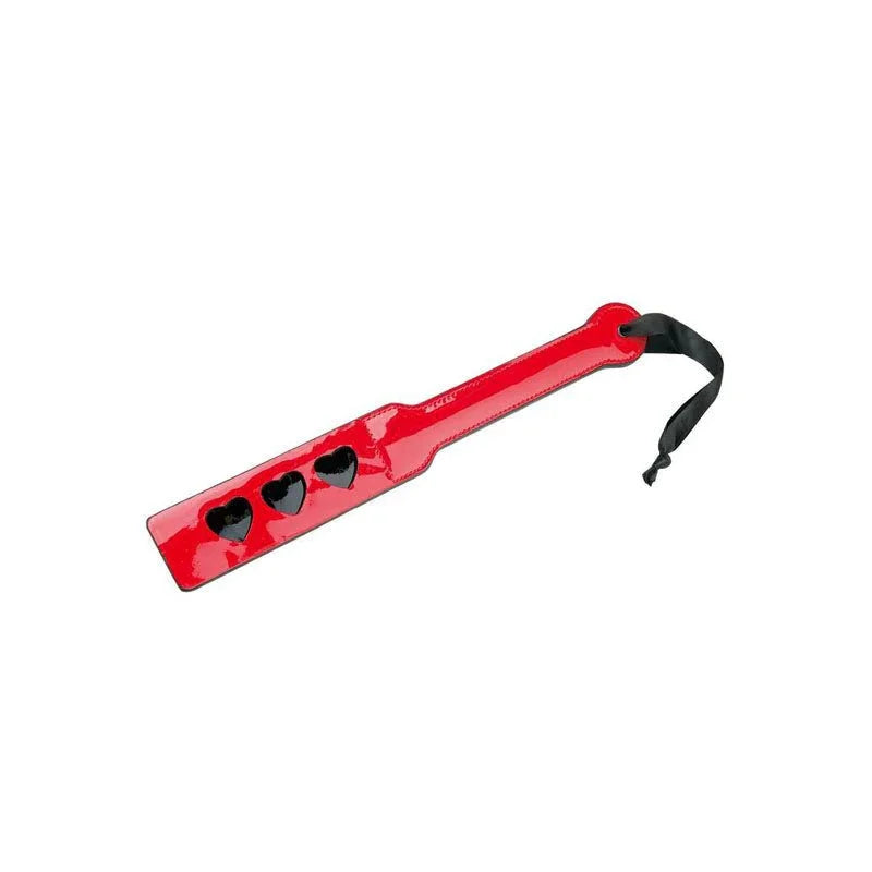 Red spanking paddle lying at an angle on white, three heart cut-outs and a wrist loop