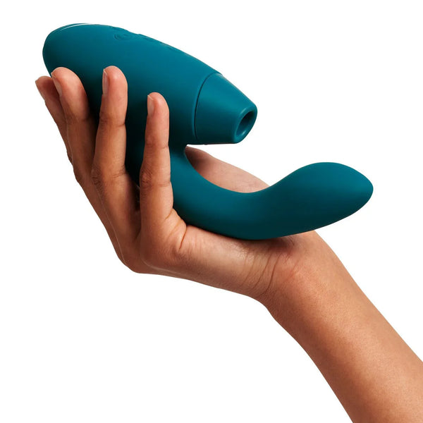 Womanizer Duo 2 in Petrol resting on an open hand, suction head and G-spot arm