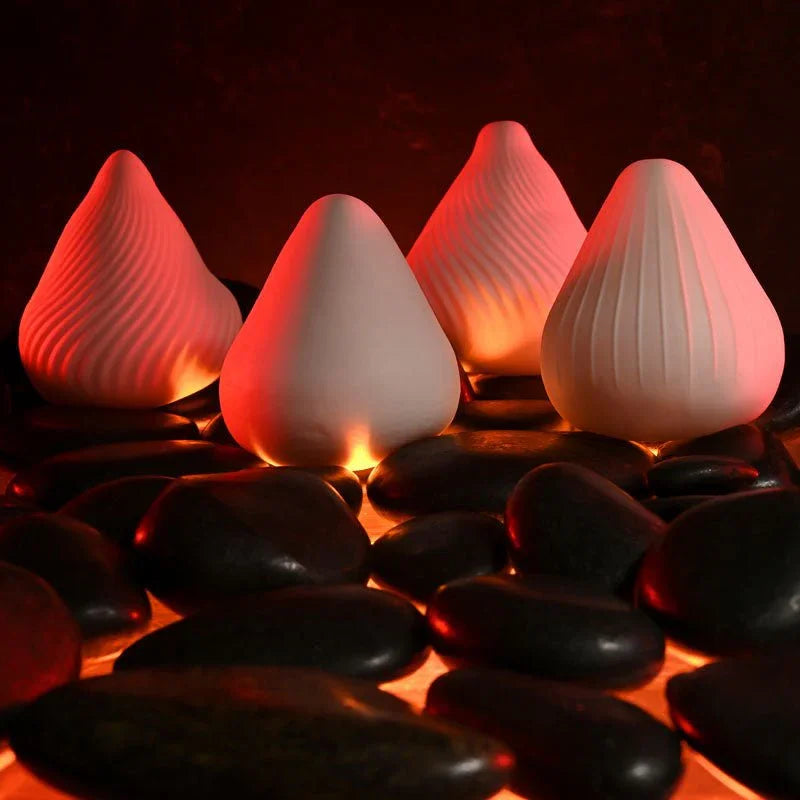 Four Fuji strokers with different surface textures lined up on stones