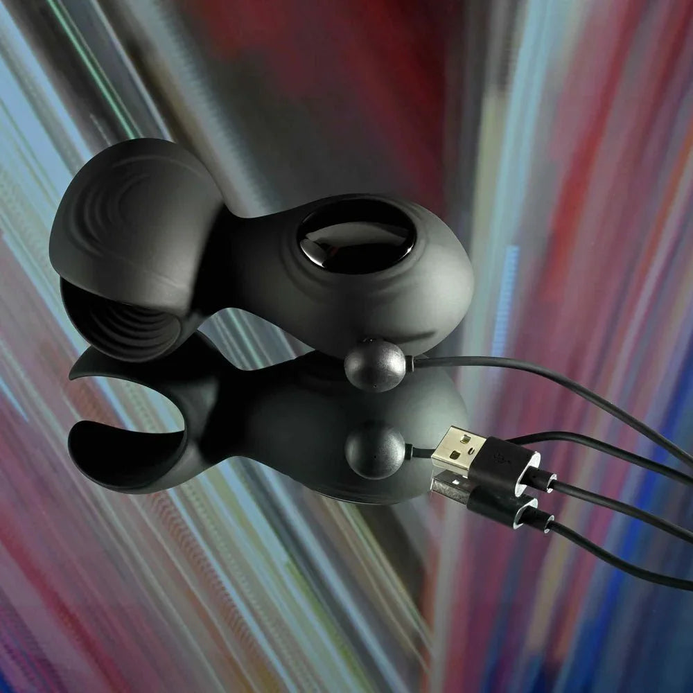 Handy Helper stroker with its USB charging cable attached to the contacts on the body