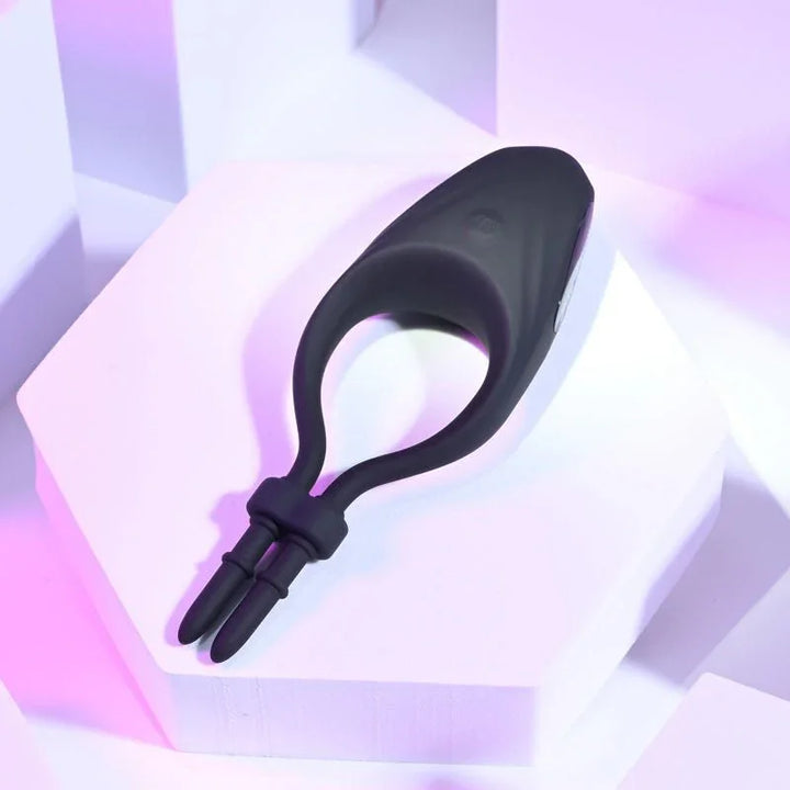 Perfect Fit lasso cock ring on a lilac block, adjustable cord hanging loose
