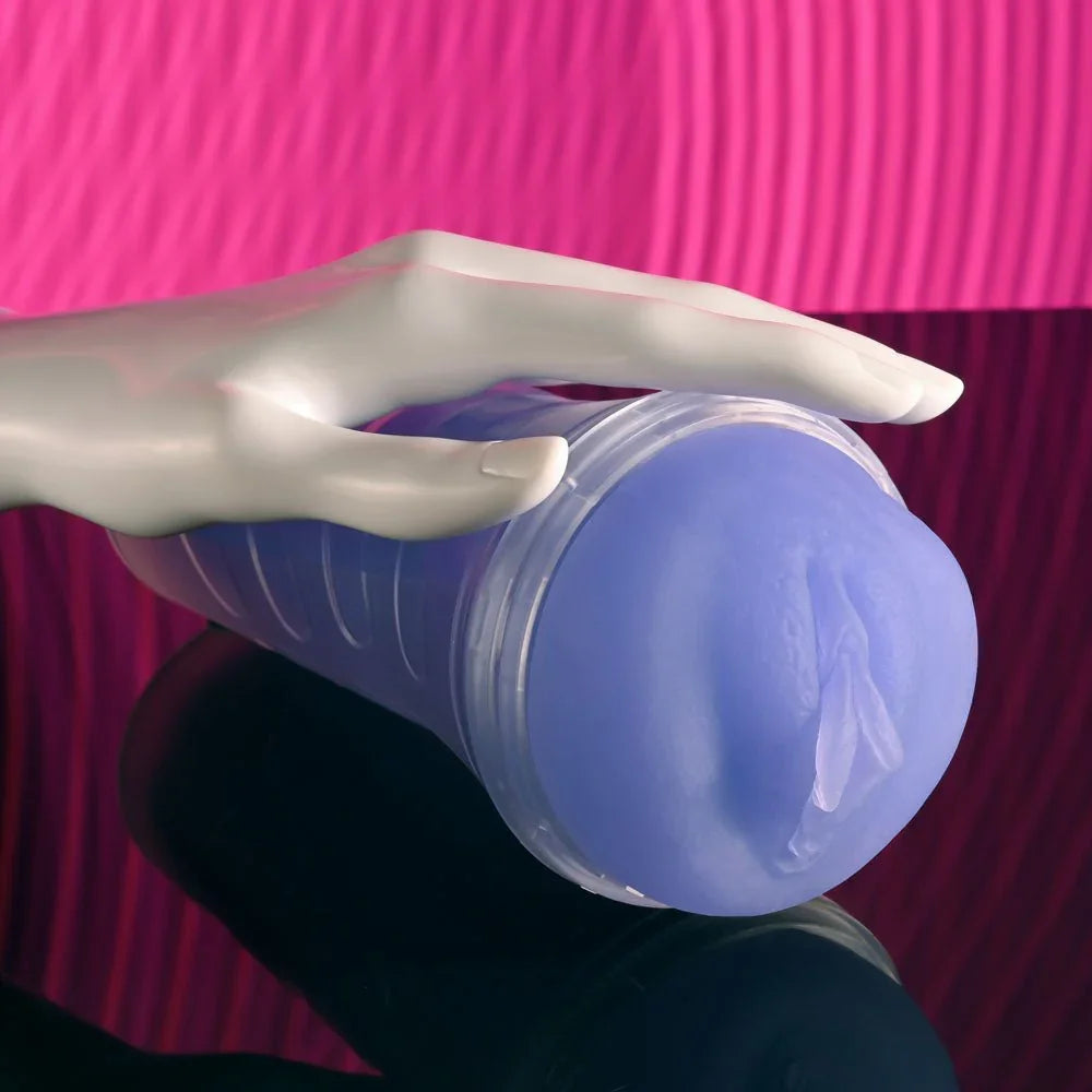 A hand resting on the Pop On The Glow stroker as it lies on its side