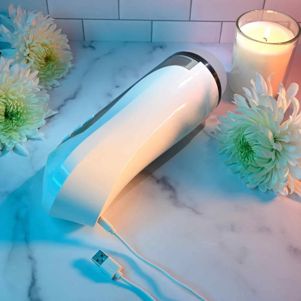 Stroking Buddy lying on marble with its USB charging cable plugged in
