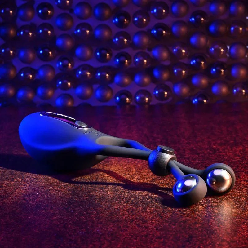 The Big Bang lasso ring lying on a dark surface, weighted ball ends to the right