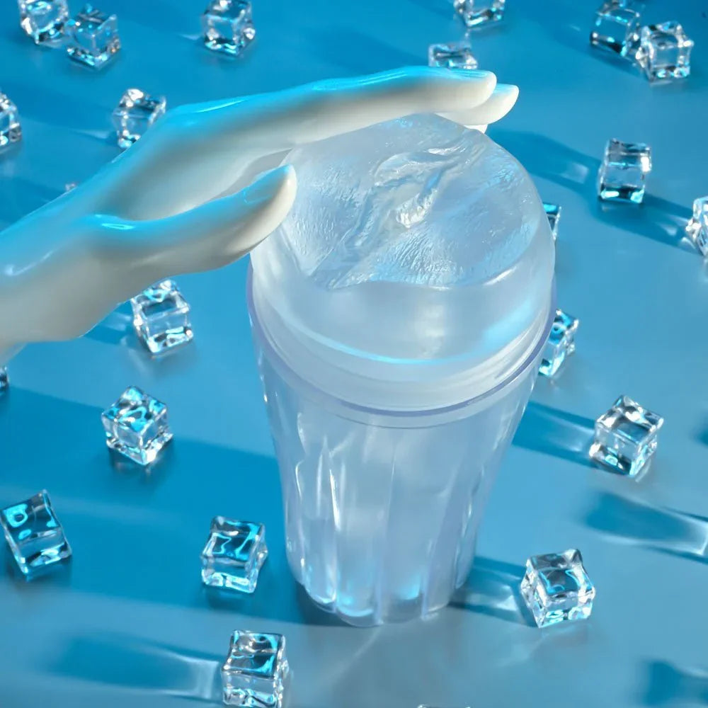 A hand resting on The Clear Choice stroker among ice cubes