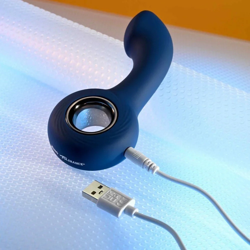 The Reach massager with its USB charging cable attached beside the metal ring handle
