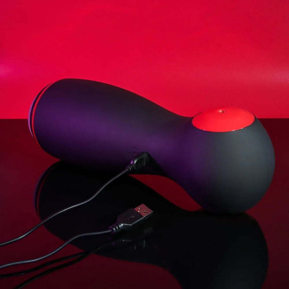 Tight Squeeze lying down with its USB charging cable plugged in