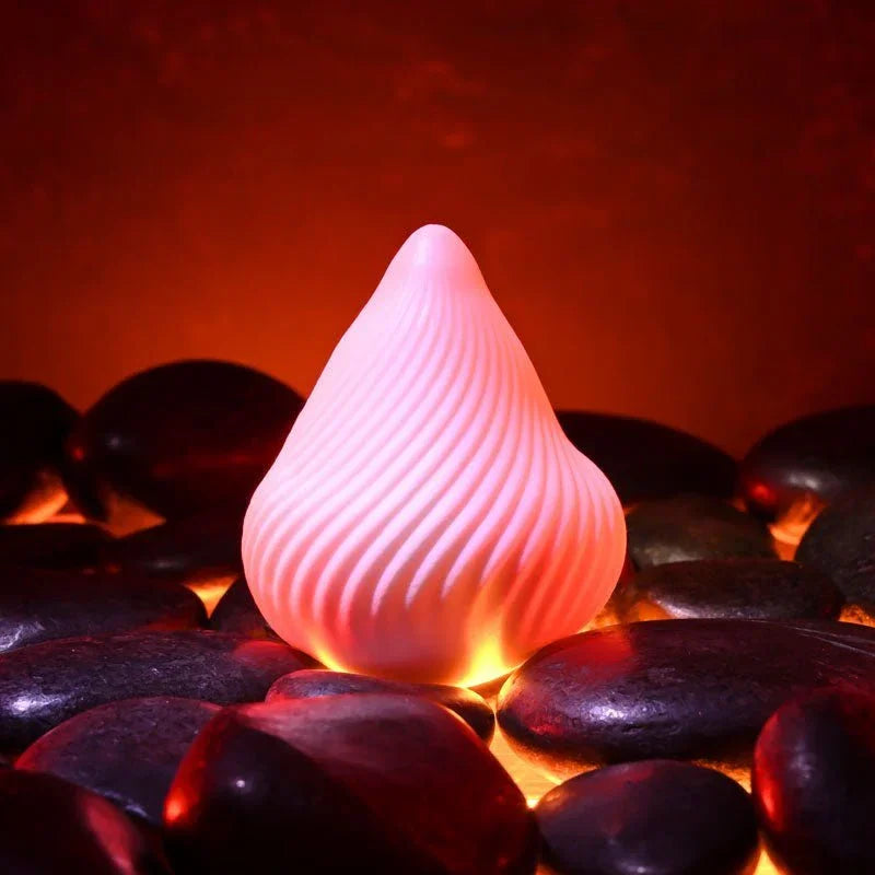 Vesuvius white ridged cone stroker standing upright on dark stones