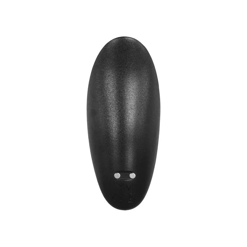 The wireless remote seen from above, showing its charging pins