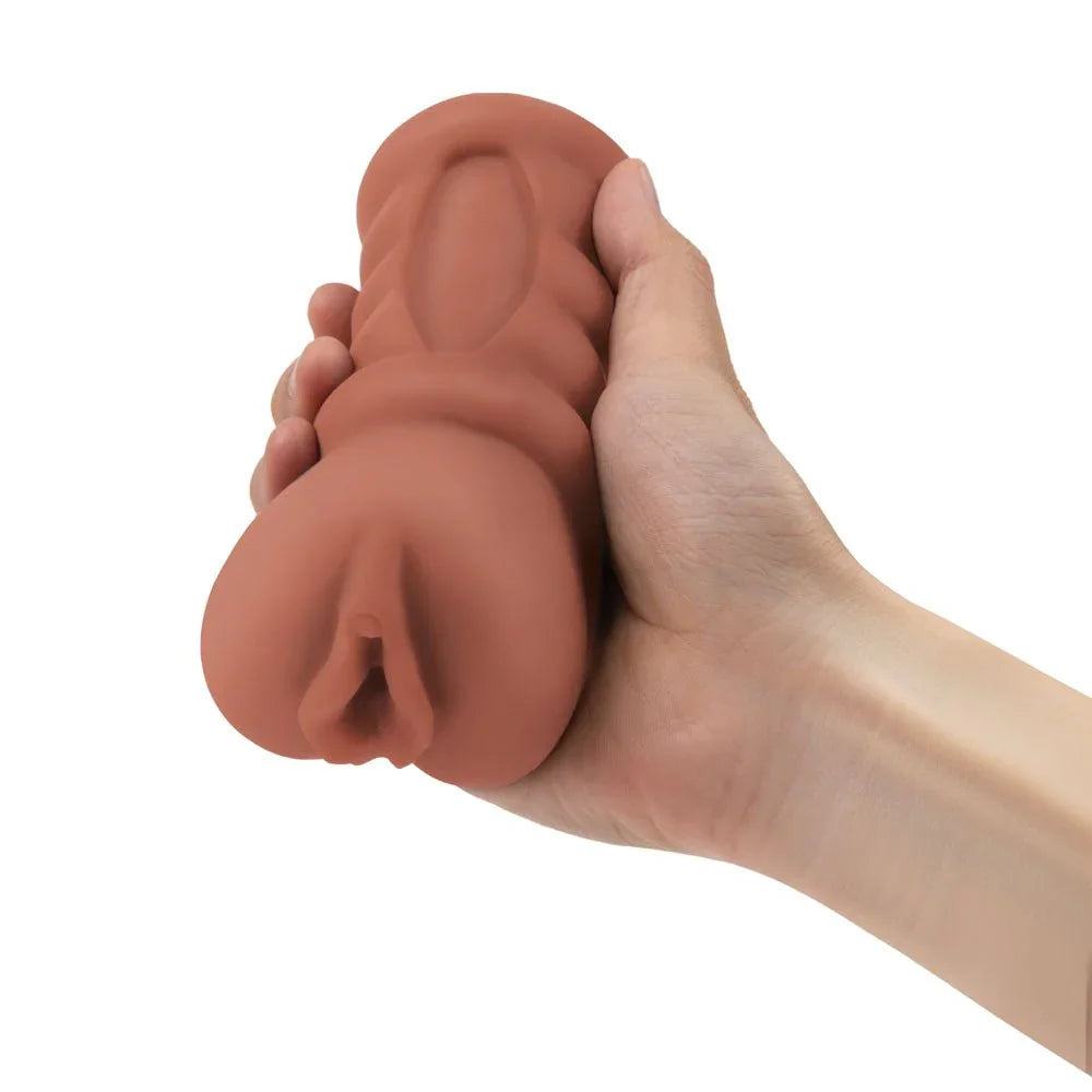 Zolo Stroke Off Latina Pussy Stroker squeezed in a hand to show how soft the tan sleeve is